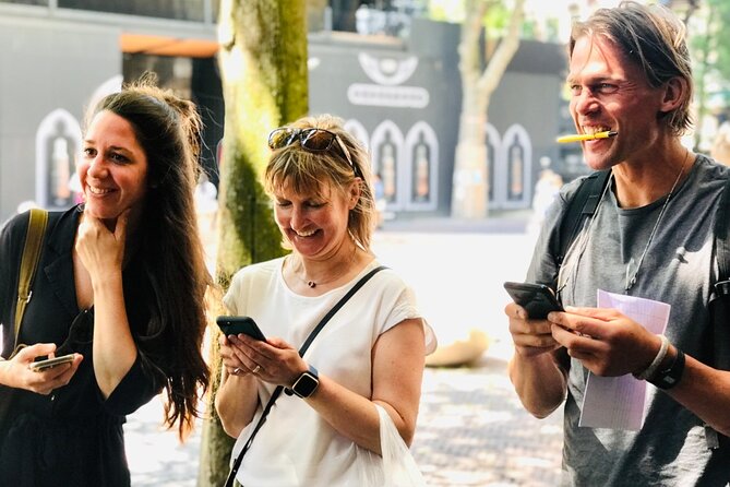 Discover Bruges with a self-guided Outside Escape city game tour! - Café terraces and sculpture at Walplein